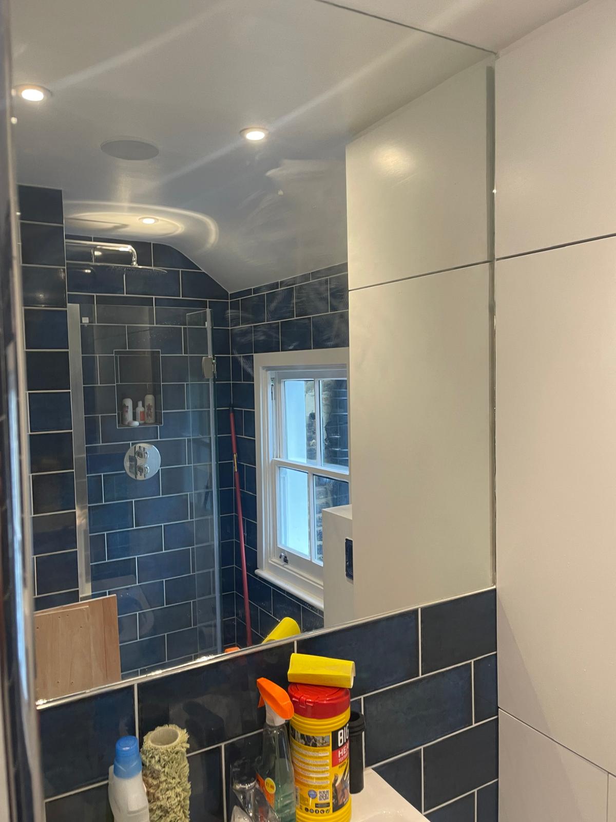 White bathroom vanity with integrated mirror cabinet and marble wall finish